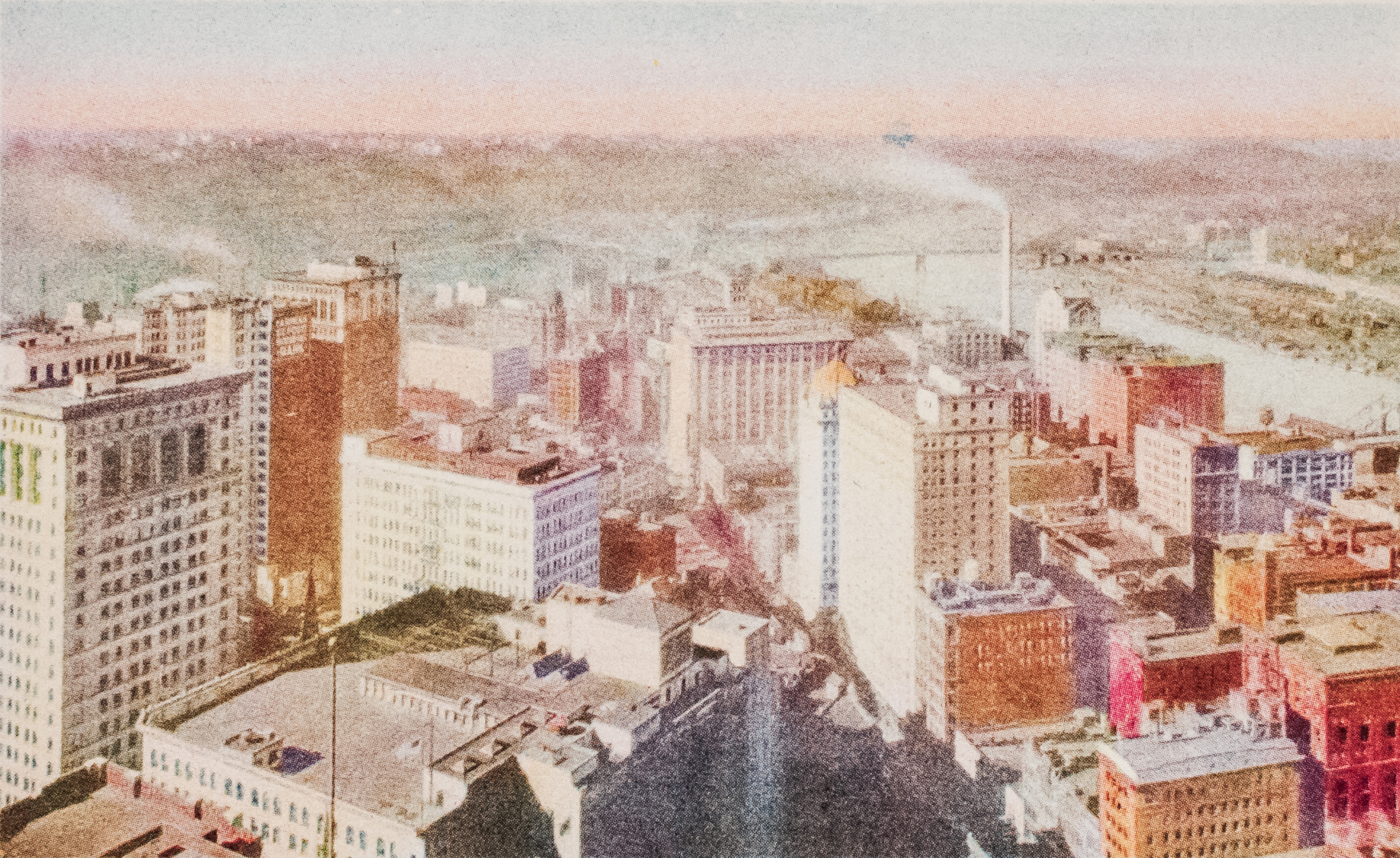 An old aerial photograph of pittsburgh - showing the city, and the river, sky,  and the surrounding wilderness